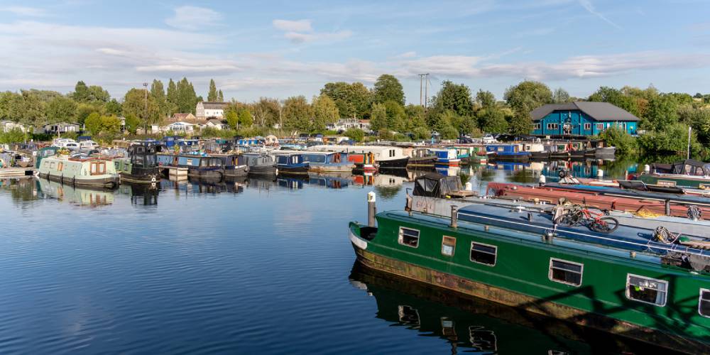 Narrowboats moored at Roydon Marina beside calm waters